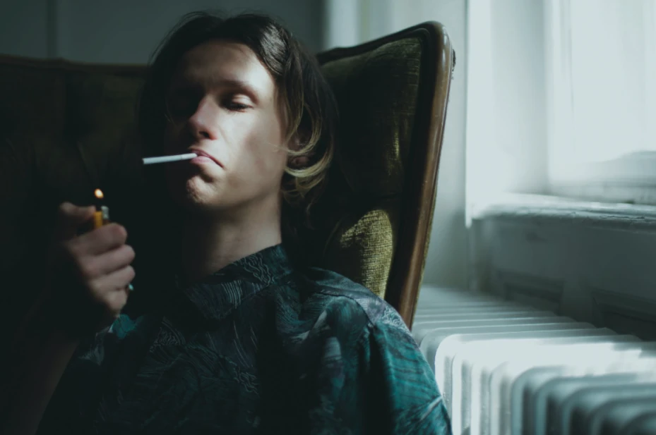 A man enjoys medical cannabis at a sober living home.